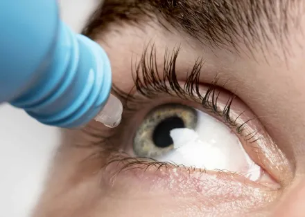 man using eye drops close up scaled